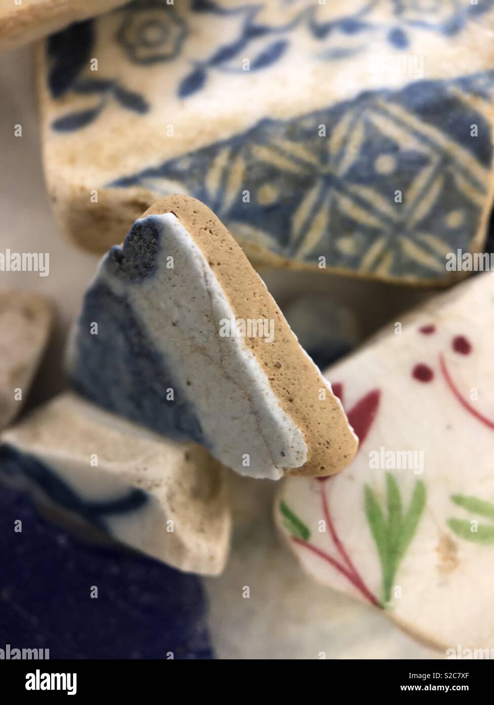 Willow ware blue and whitePottery shards found Mudlarking River Thames London during low tide Stock Photo