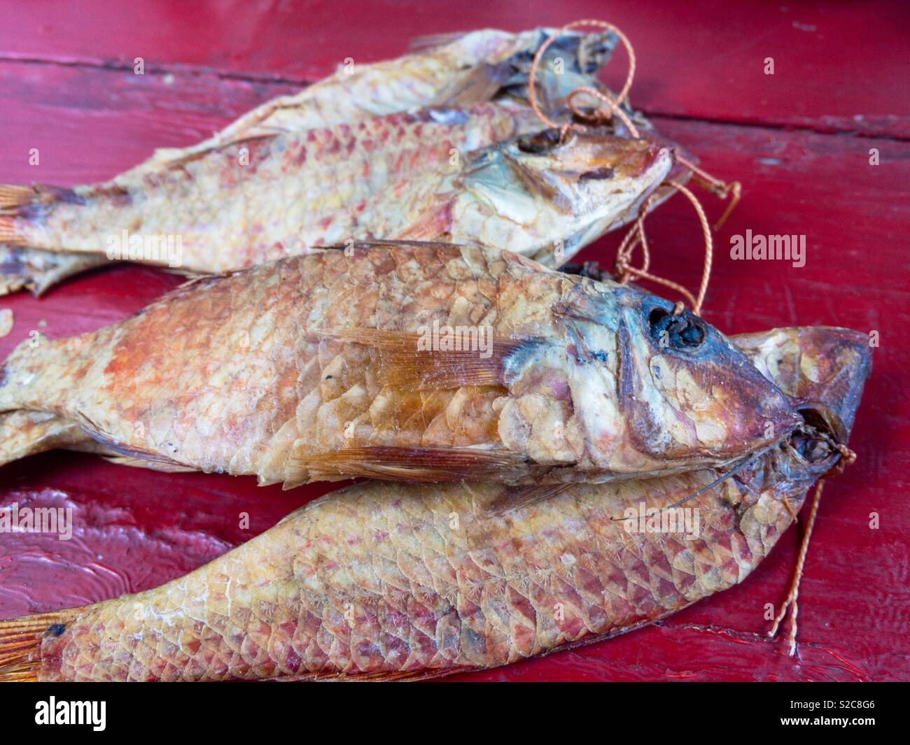 Dry fish on a red table, Ukraine - Smartphone Captured Stock Image