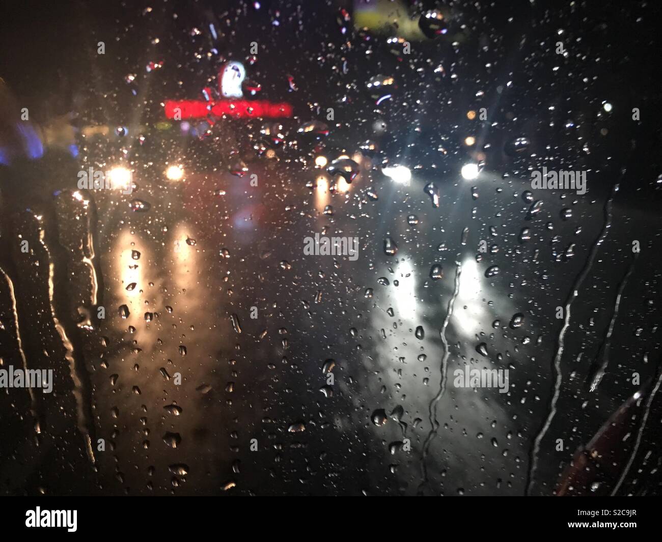 Car lights during a strong rain Stock Photo