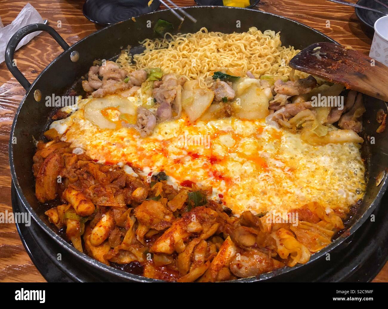 Chicken Galbi cooking in a large pan with chicken, cheese and mixed vegetables. - Smartphone Captured Stock Image