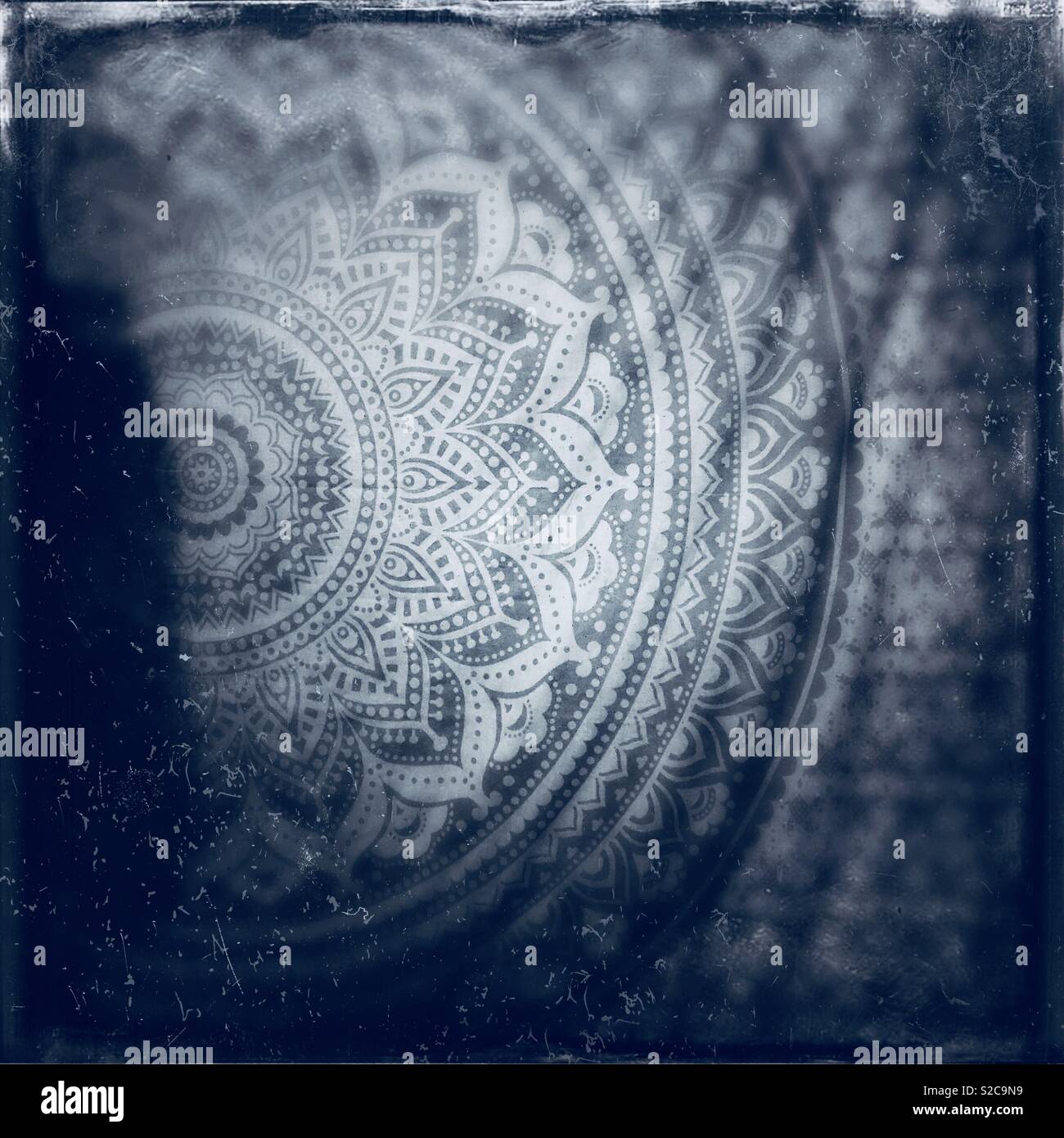 Black and white photo of a beautiful bohemian style tapestry hanging on