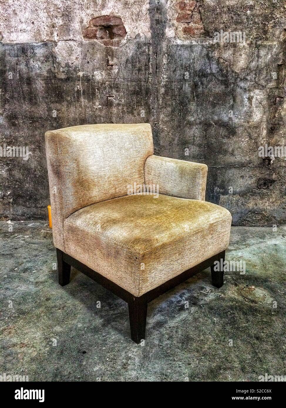 Old vintage armchair in an abandoned building Stock Photo