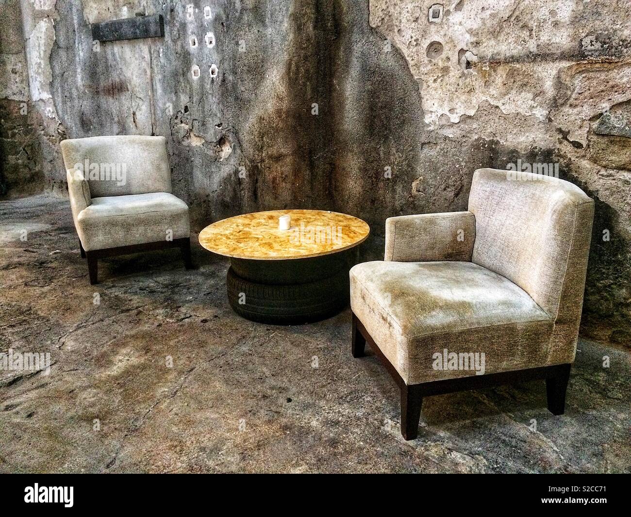 Two vintage armchairs in the hall of an old industrial building Stock Photo