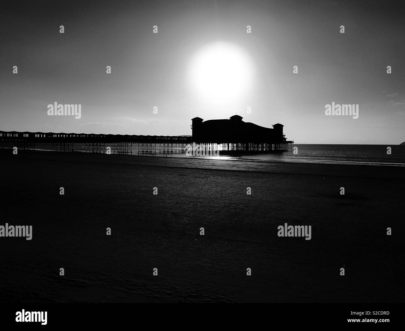 The Grand Pier in Weston-super-Mare, UK silhouetted against the setting sun on an October afternoon Stock Photo
