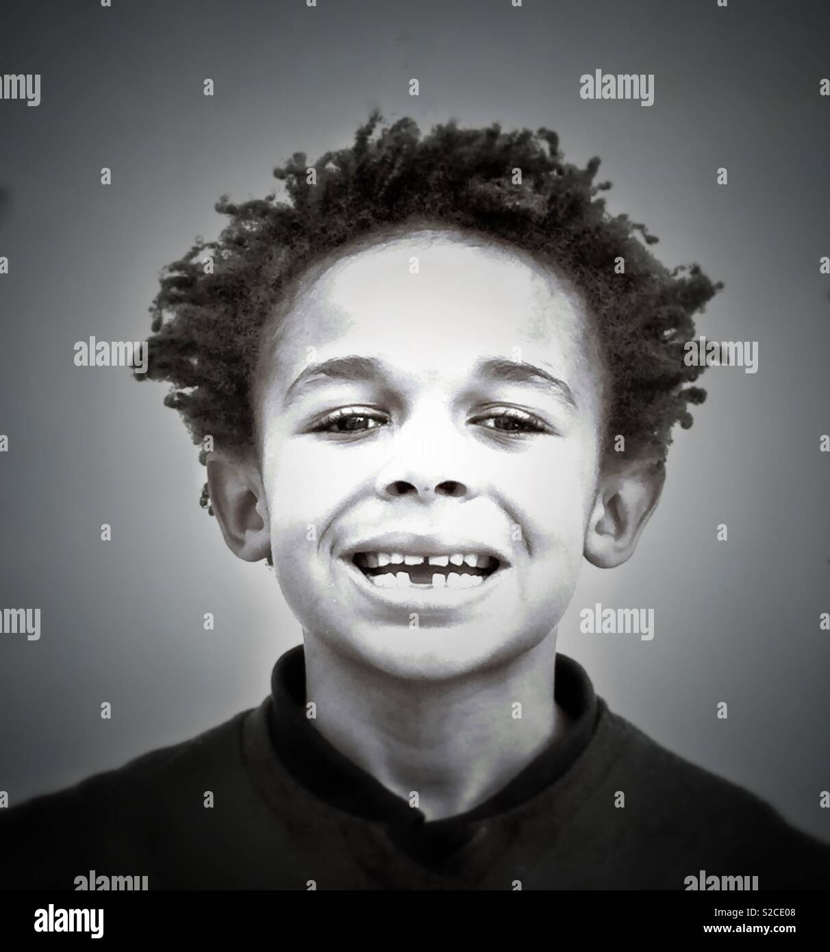 A boy shows off his missing tooth. - Smartphone Captured Stock Image
