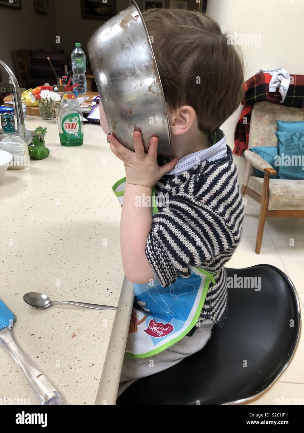 Lick the bowl!(toddler helping in the kitchen Stock Photo - Alamy