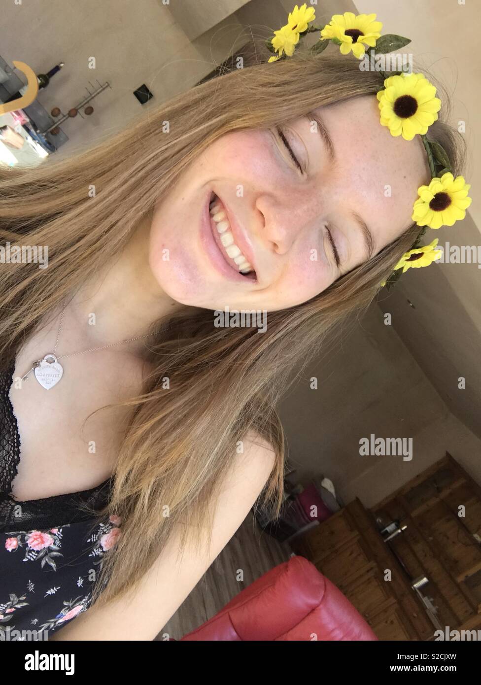 Girl in flower crown expressing a joyful smile Stock Photo