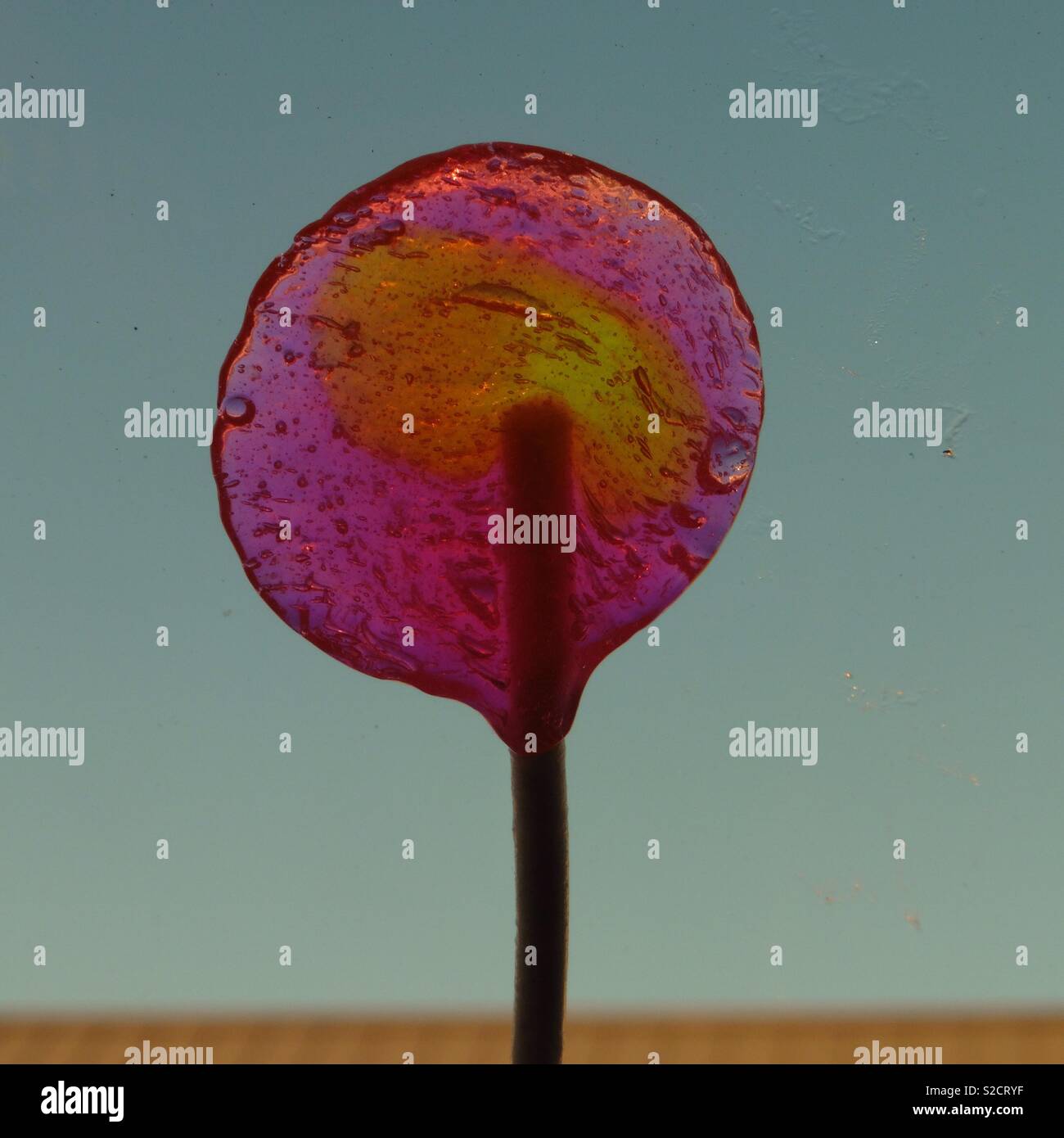 A colorful partially eaten lollipop Stock Photo