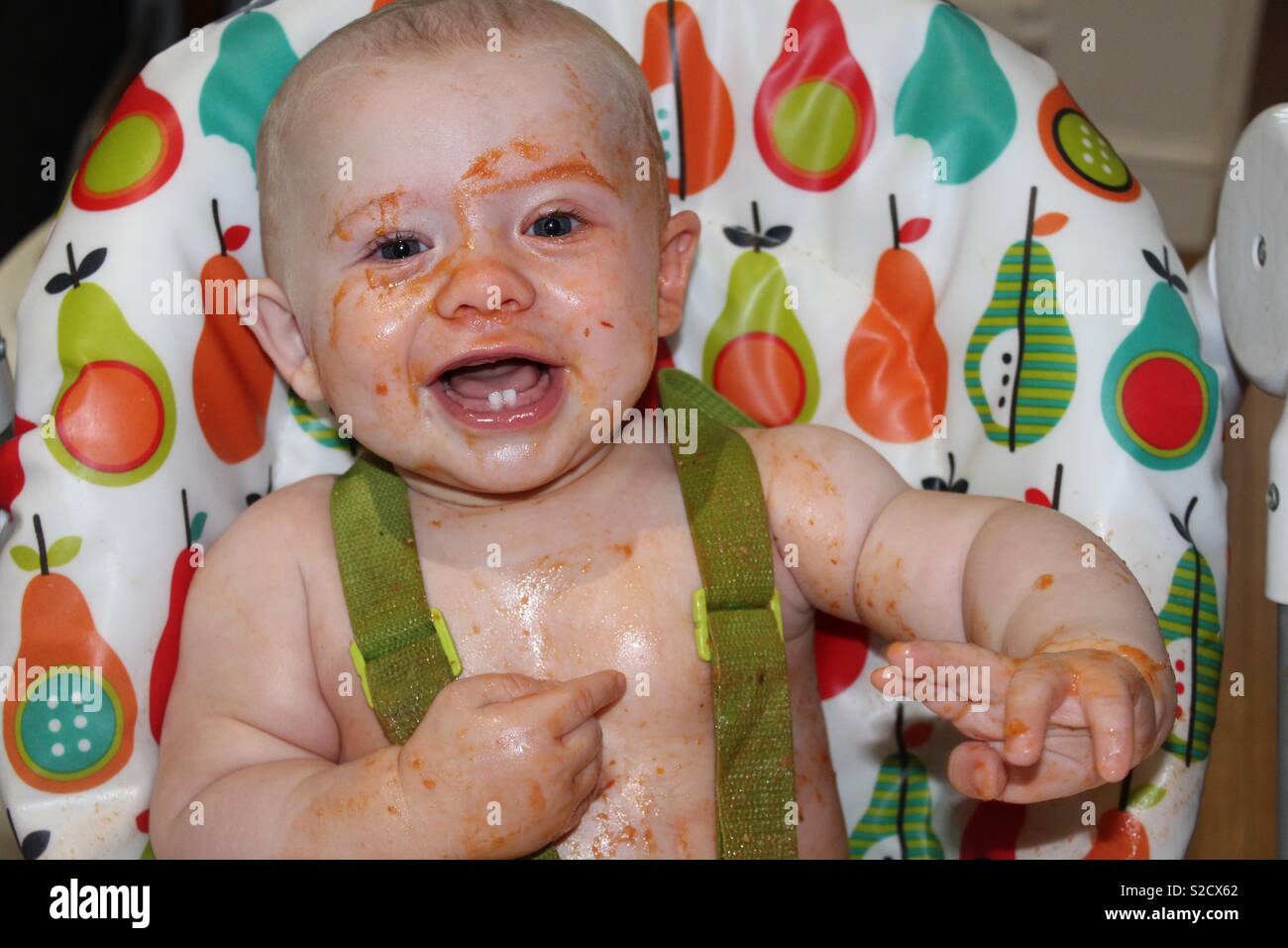 Messy baby at tea time Stock Photo