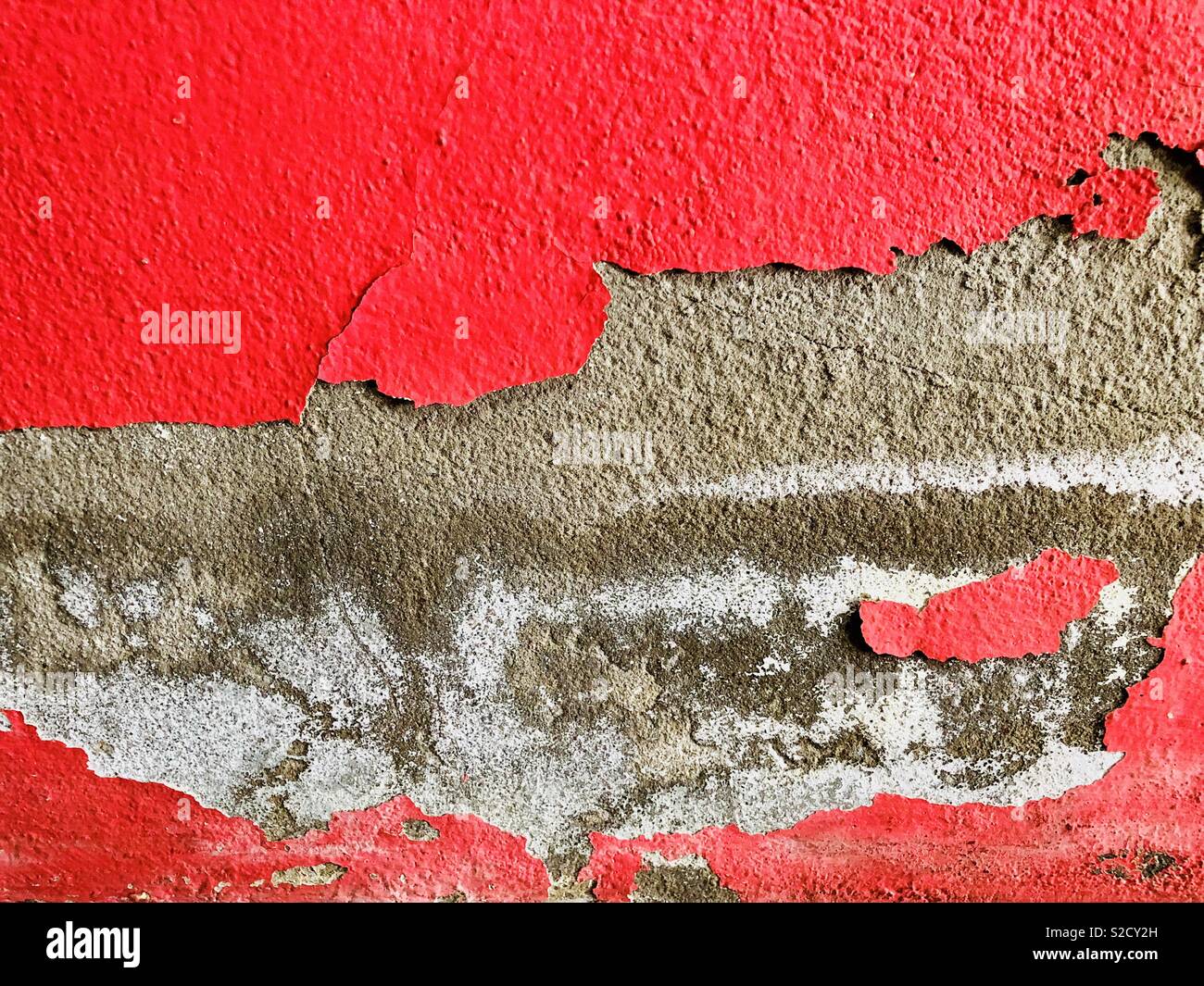 Abstract cracks red painted on concrete texture wall background Stock Photo