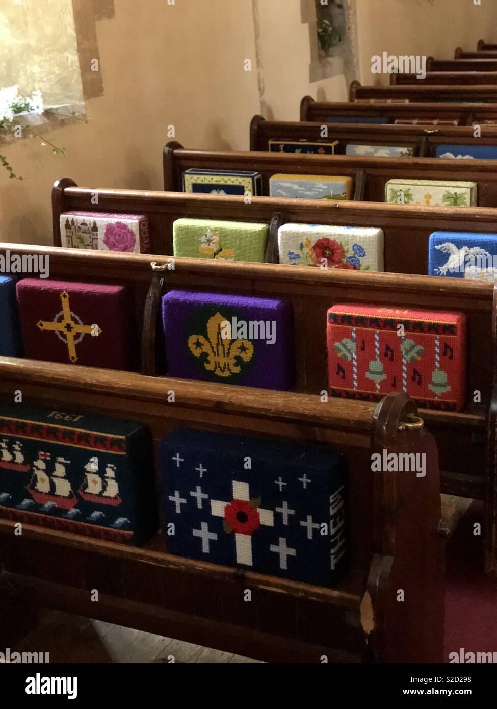 Embroidered kneeling cushions on church pews Stock Photo Alamy