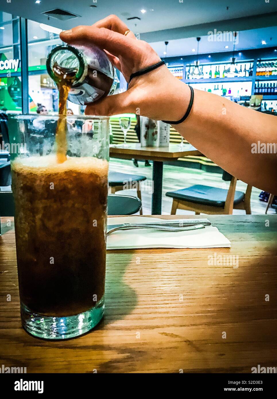 Bottle of Diet Pepsi poured into glass in a restaurant - Smartphone Captured Stock Image