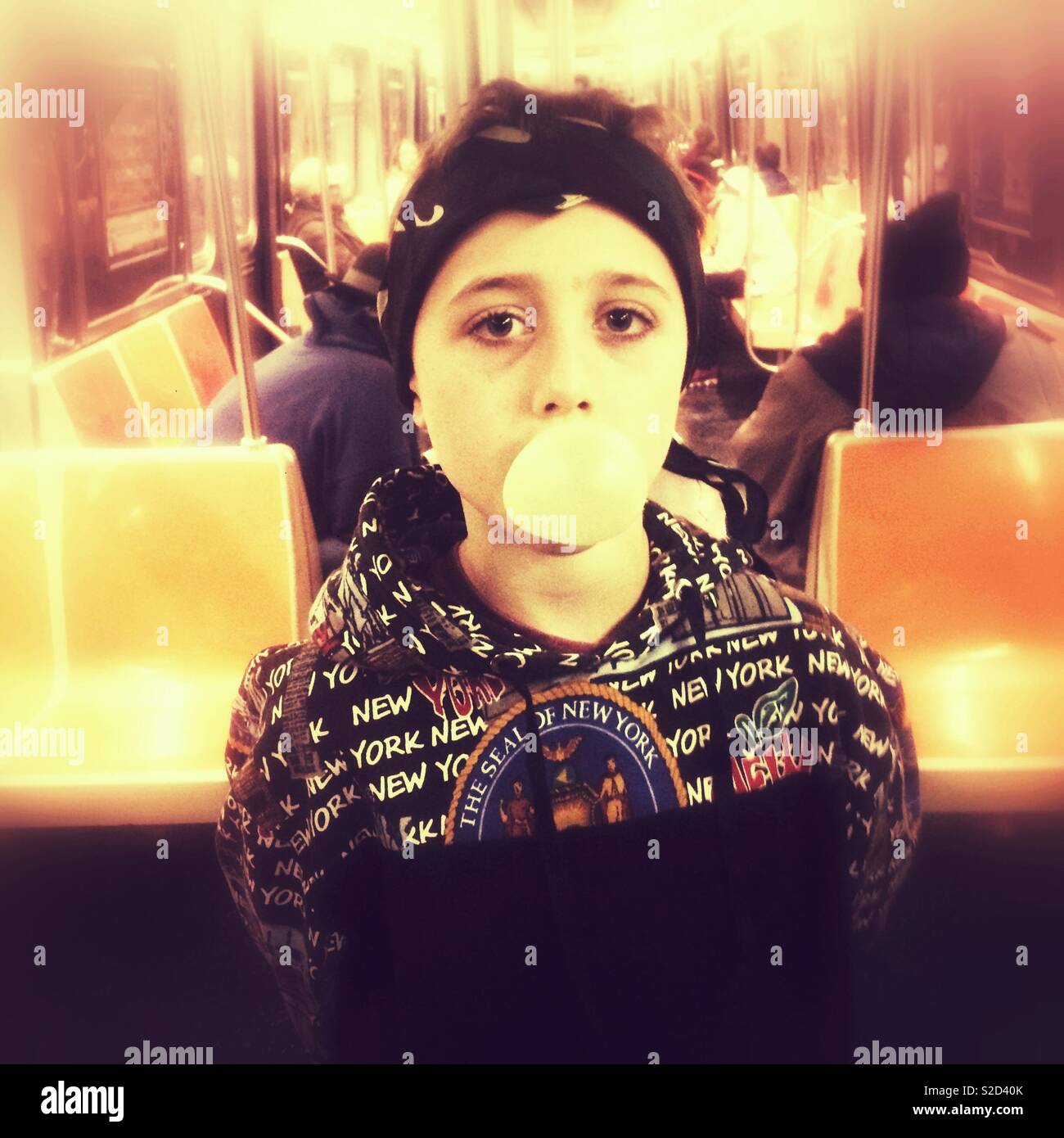 Nine year old boy on the subway, New York City, United States of America. Stock Photo
