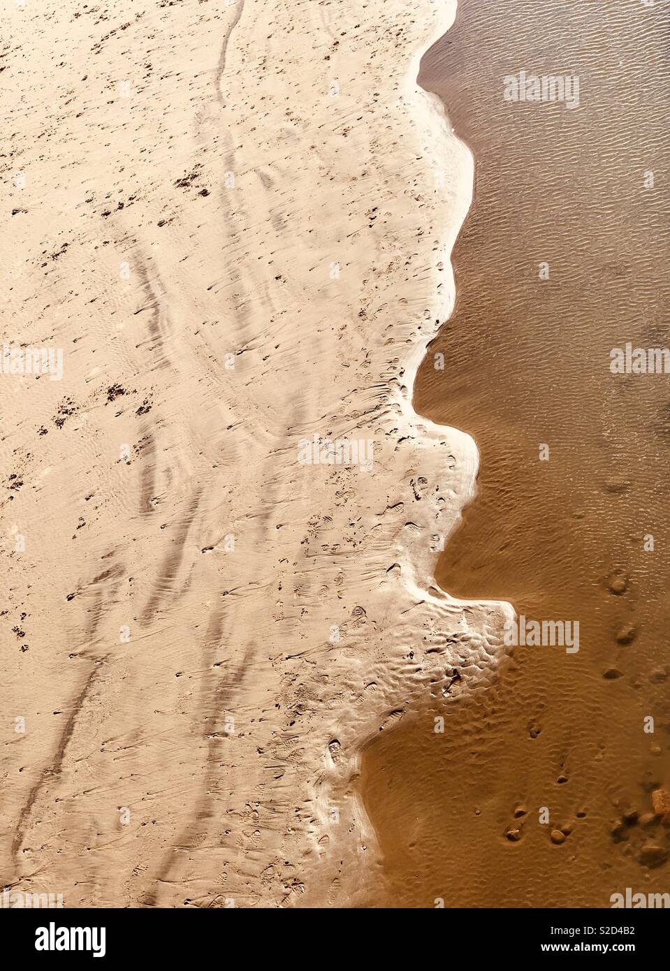 Abstract formed when the sea meets a sandy beach - Smartphone Captured Stock Image