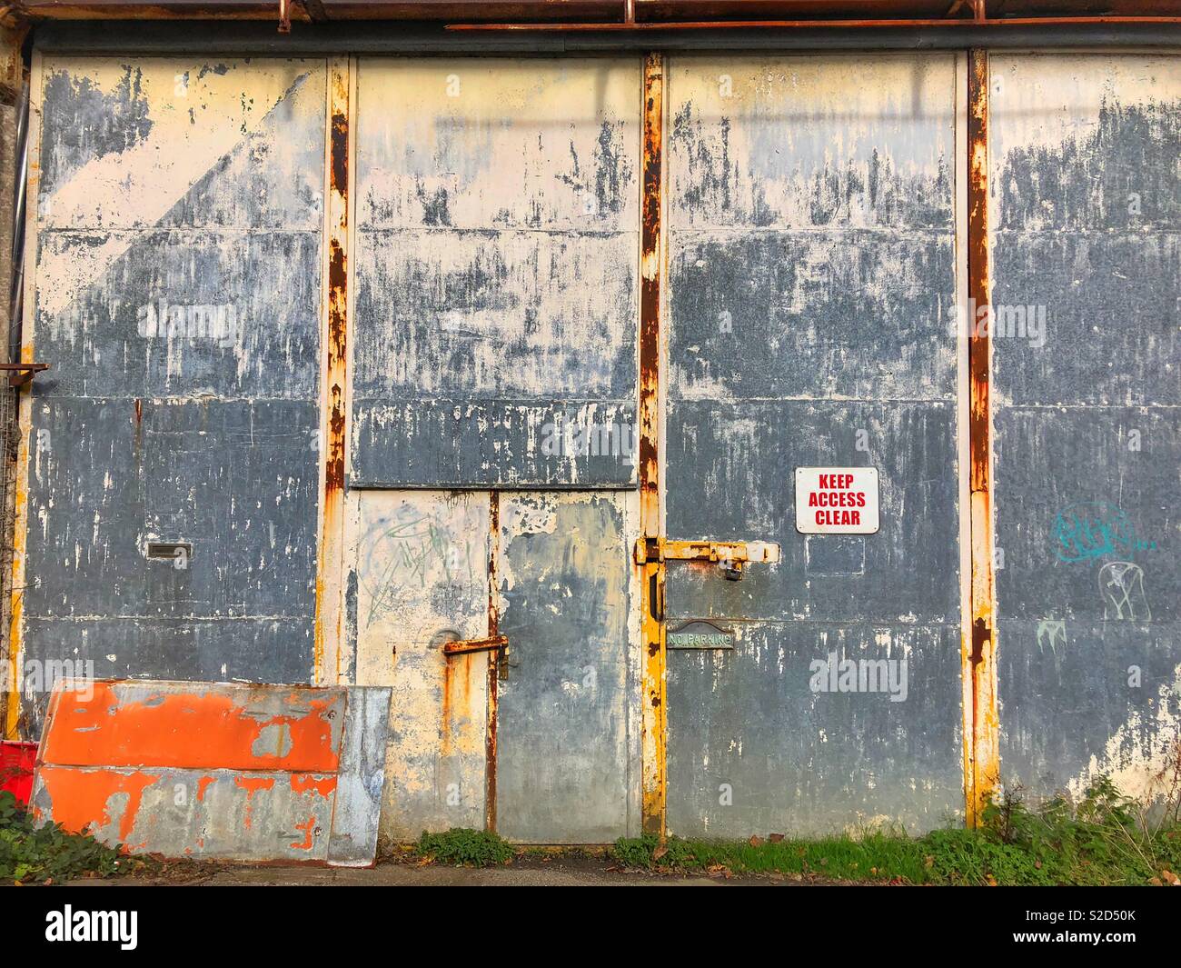 Old workshop doorway with peeling paint. - Smartphone Captured Stock Image