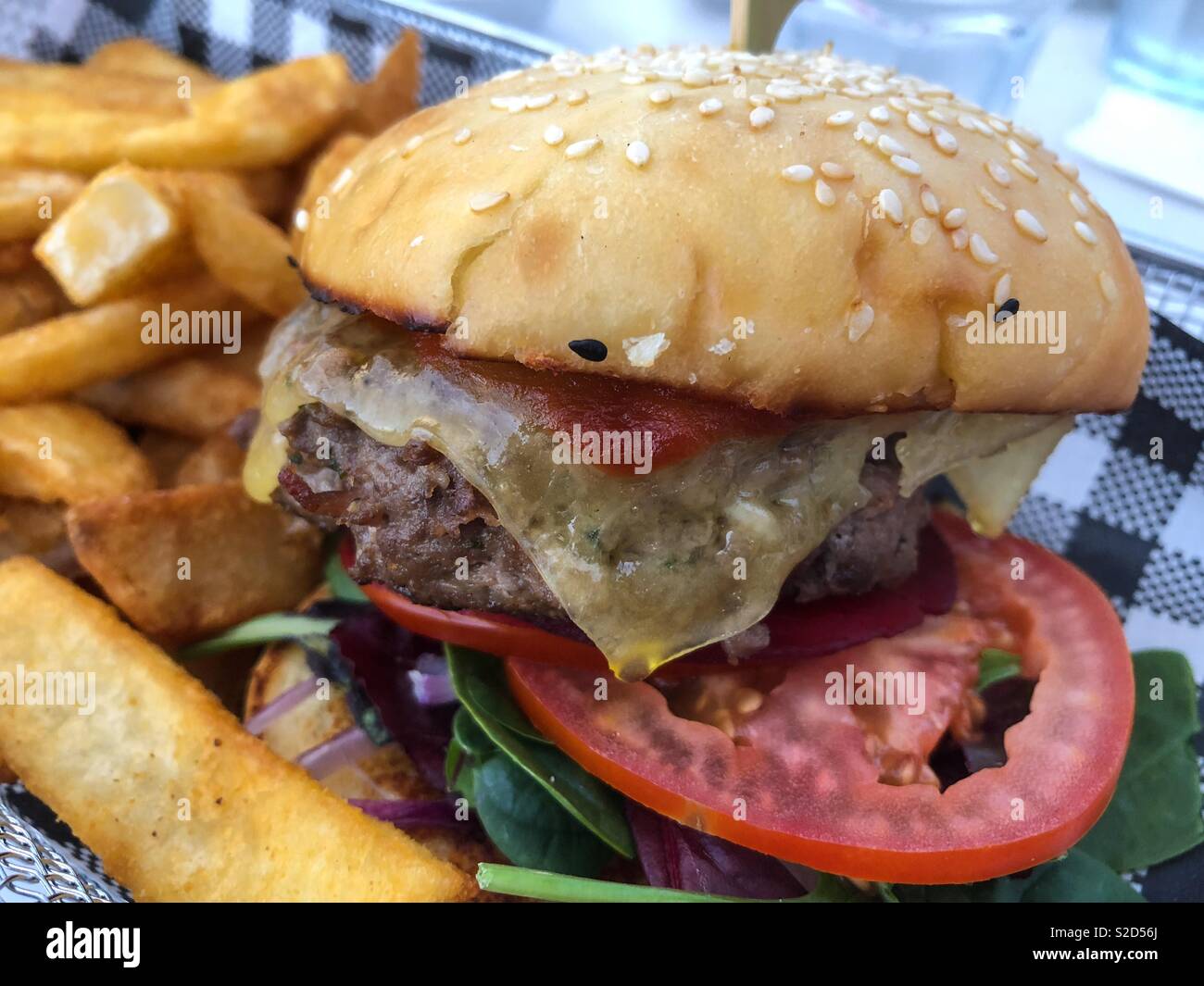 Close up of a hamburger with fries. - Smartphone Captured Stock Image