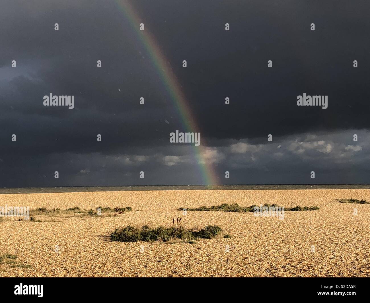 Stormy seaside rainbow Stock Photo - Alamy