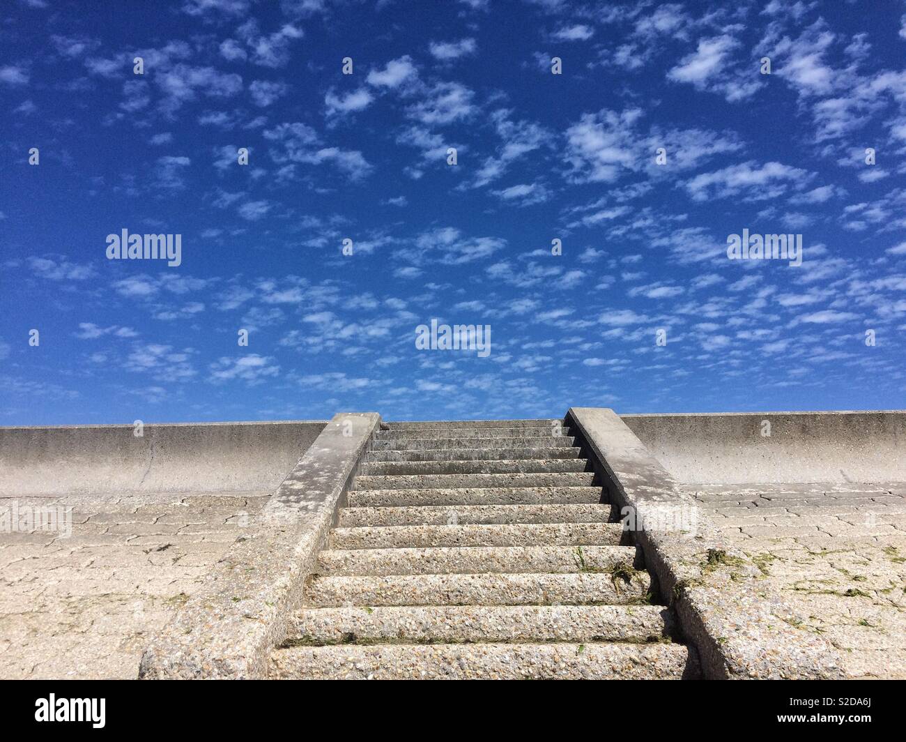 Concrete steps against blue sky and clouds near the seaside,at Lepe beach,Hampshire,South UK. - Smartphone Captured Stock Image