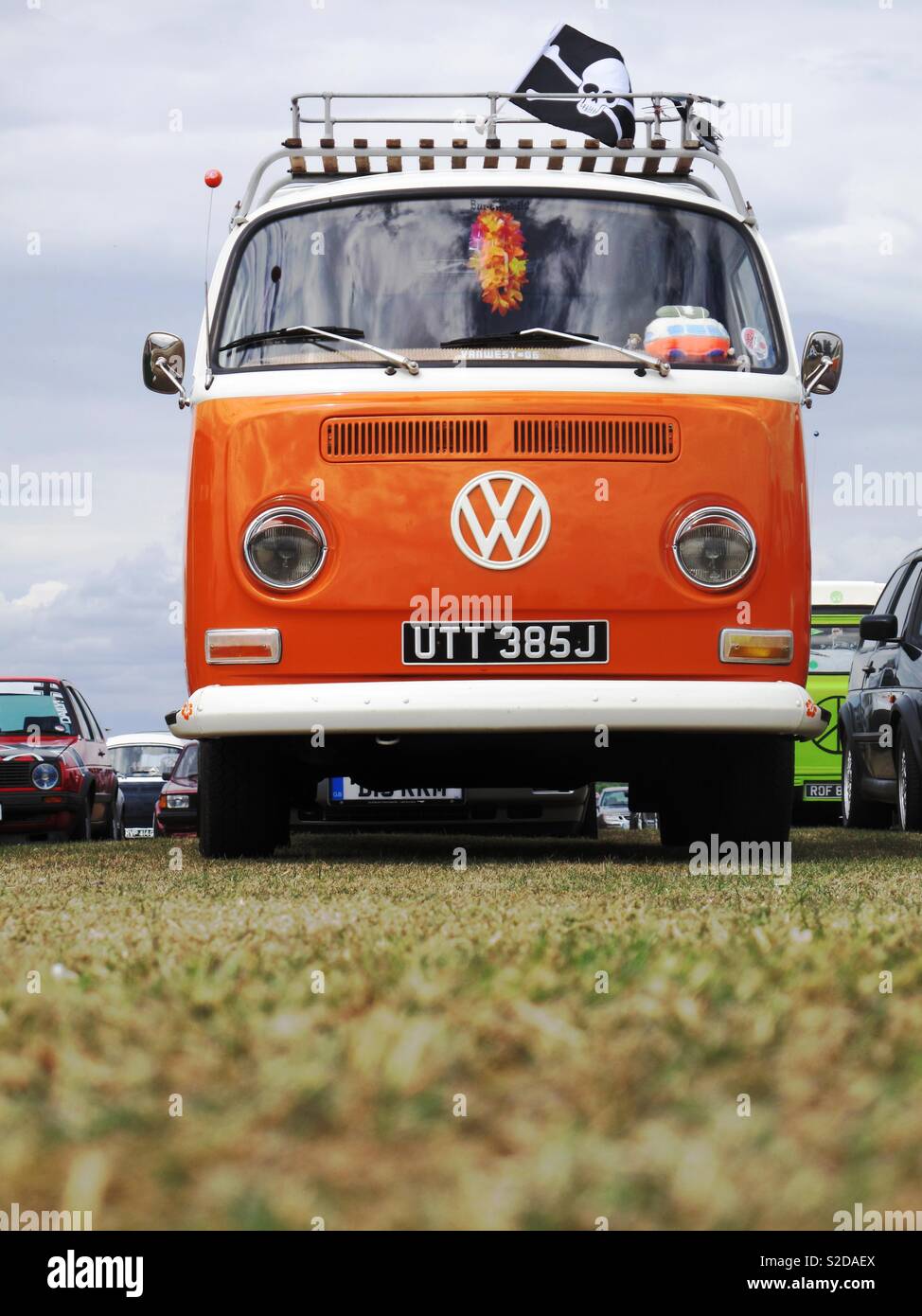 Orange Volkswagen campervan at a car show Stock Photo