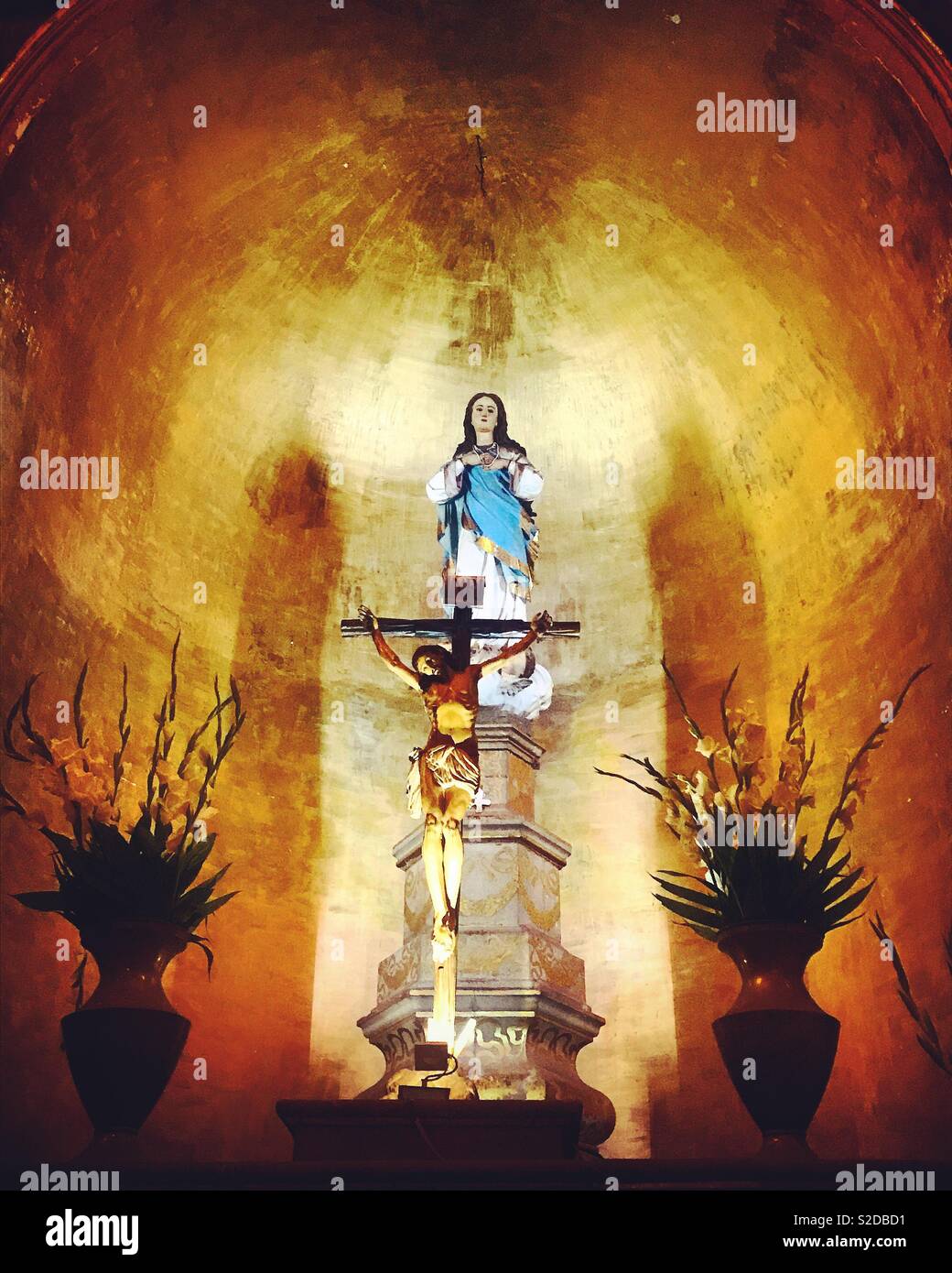 An altar to the Virgin Mary and Jesus Christ crucified decorates a church in the Compañia de Jesus church in Oaxaca, Mexico - Smartphone Captured Stock Image