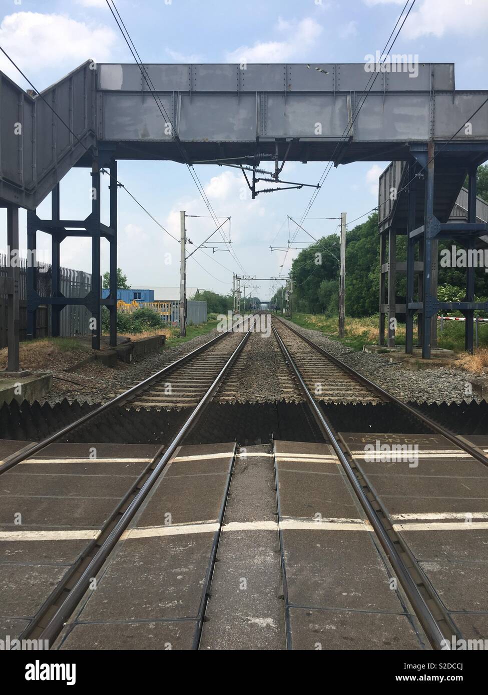 View along the train tracks from the middle of a level crossing, Waltham Cross, Cheshunt, UK Stock Photo
