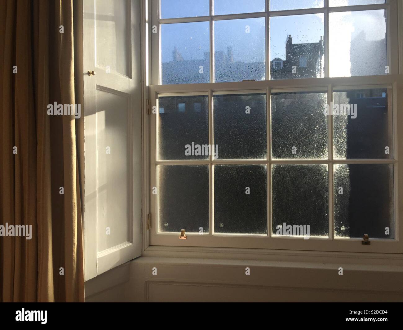 Sash window panes in Georgian house in Edinburgh, Scotland - condensation in winter sunshine Stock Photo