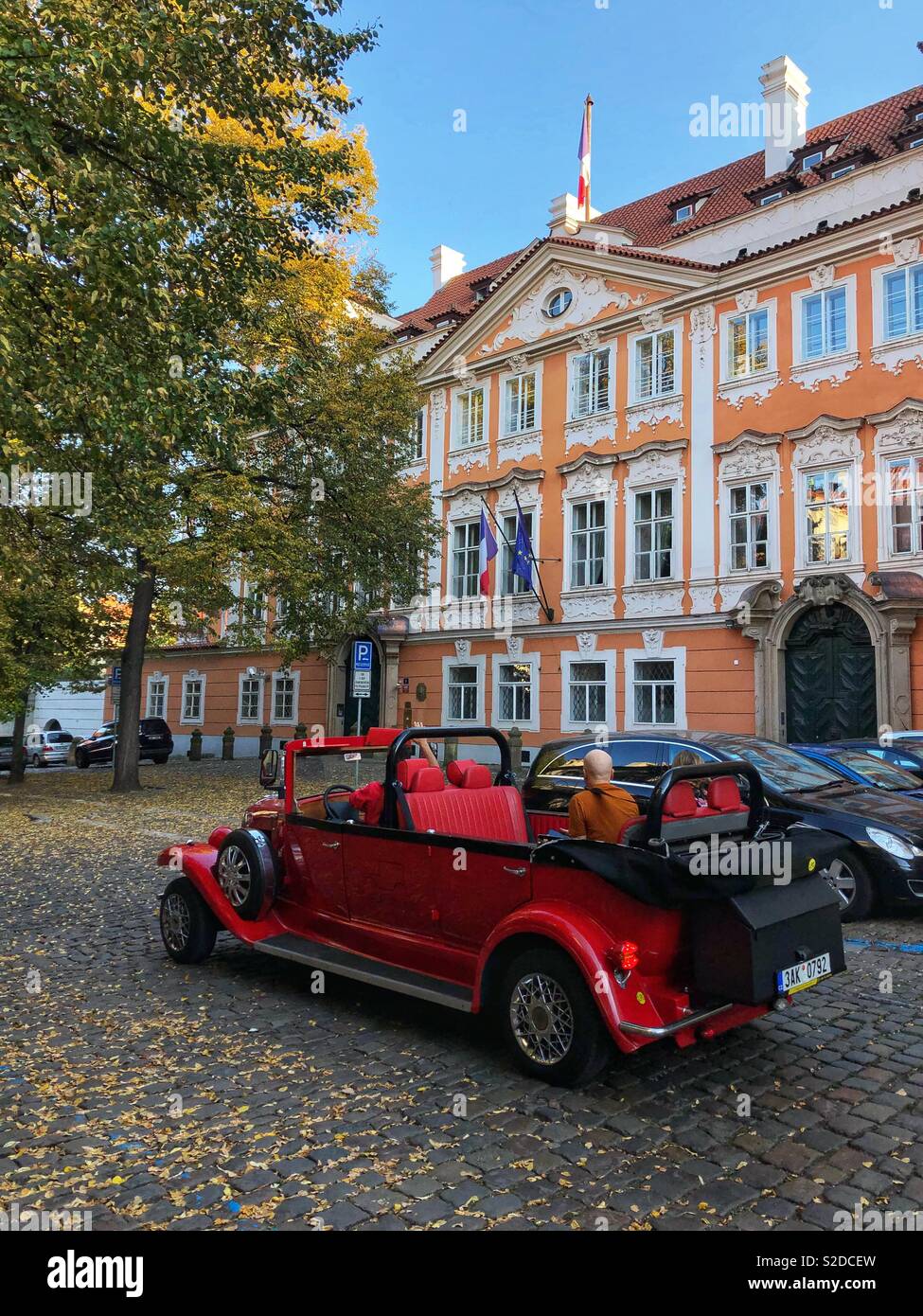 A classic red convertible in Prague. - Smartphone Captured Stock Image
