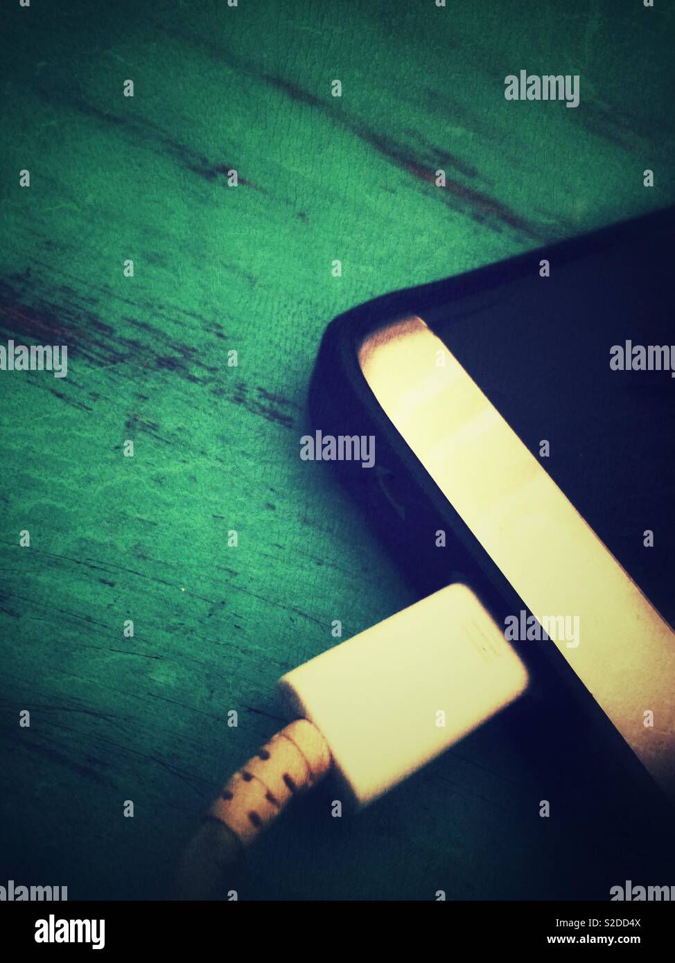 Smart phone plugged to charger Stock Photo