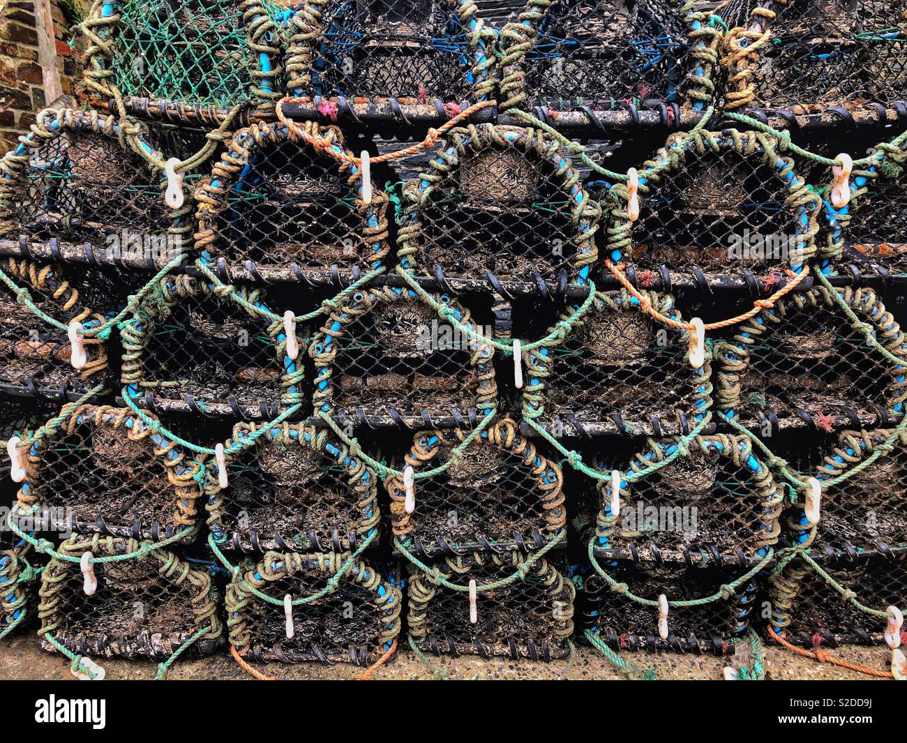 Stacked lobster pots at Port Isaac, North Cornwall, England. Stock Photo