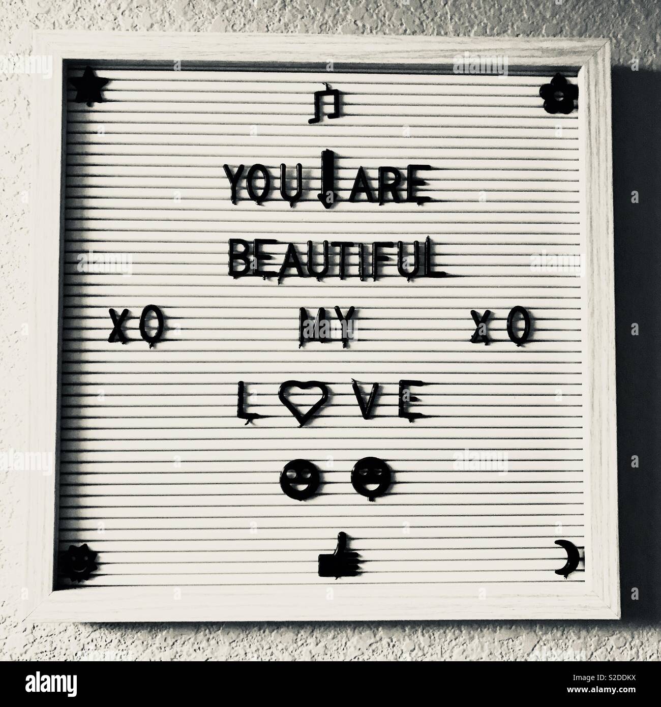 A sign with a personal messages written out, you are beautiful my love. Xoxoxo Stock Photo