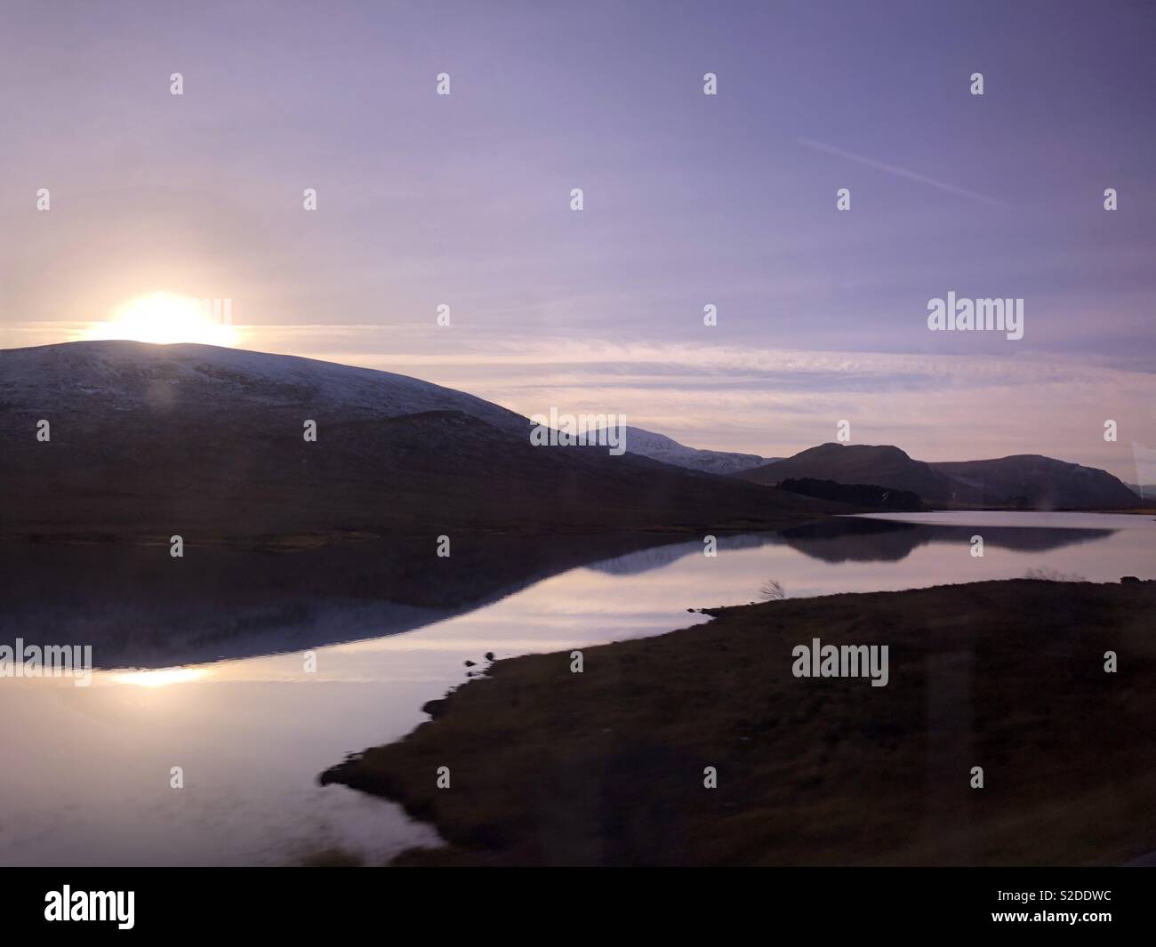 Moody sunset over highlands Stock Photo