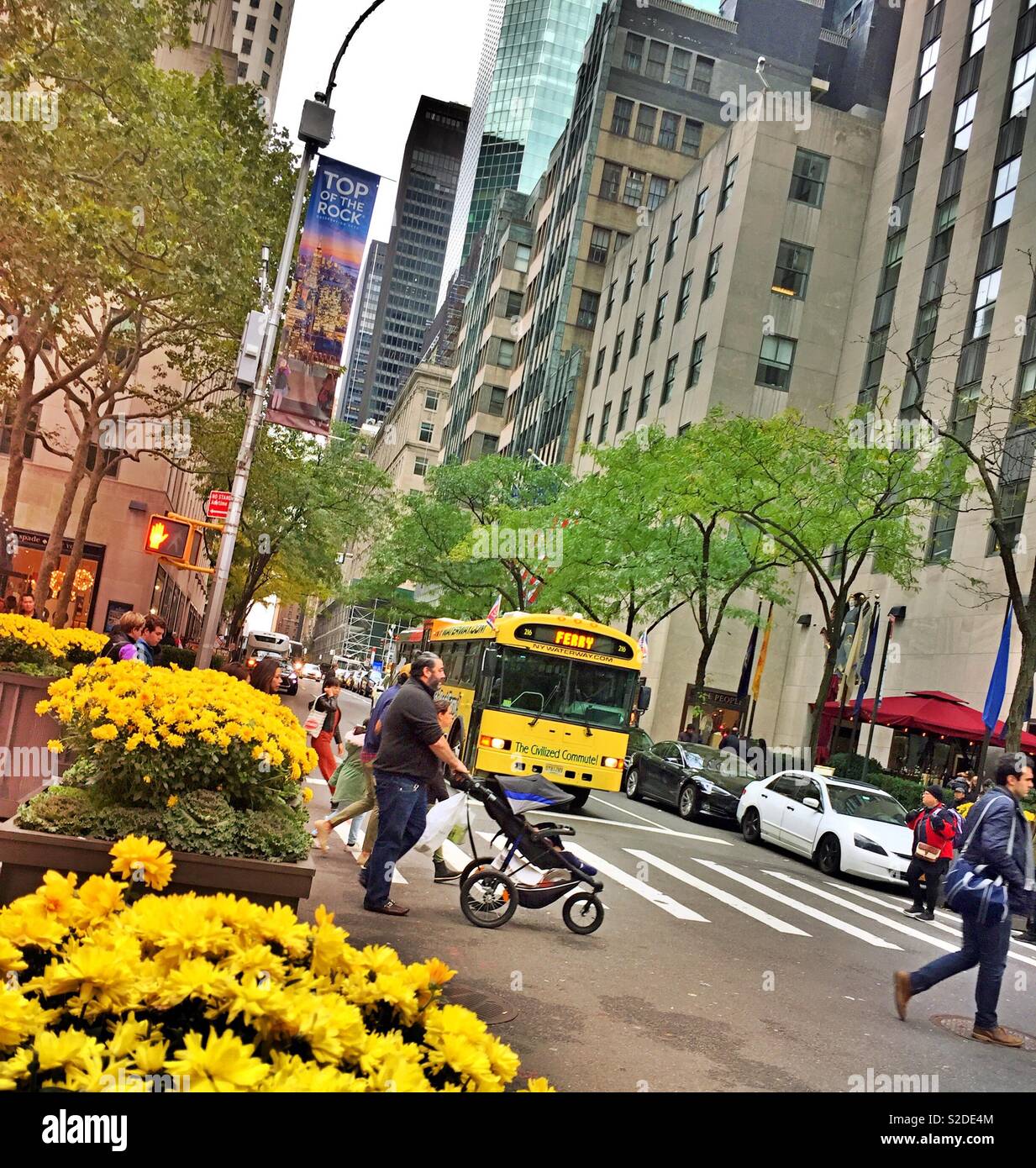 Pedestrians  and street traffic near Rockefeller Center in Midtown Manhattan, NYC, USA - Smartphone Captured Stock Image