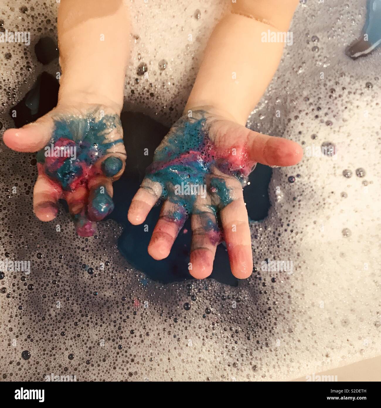 Child’s messy hands in a bubble bath Stock Photo Alamy