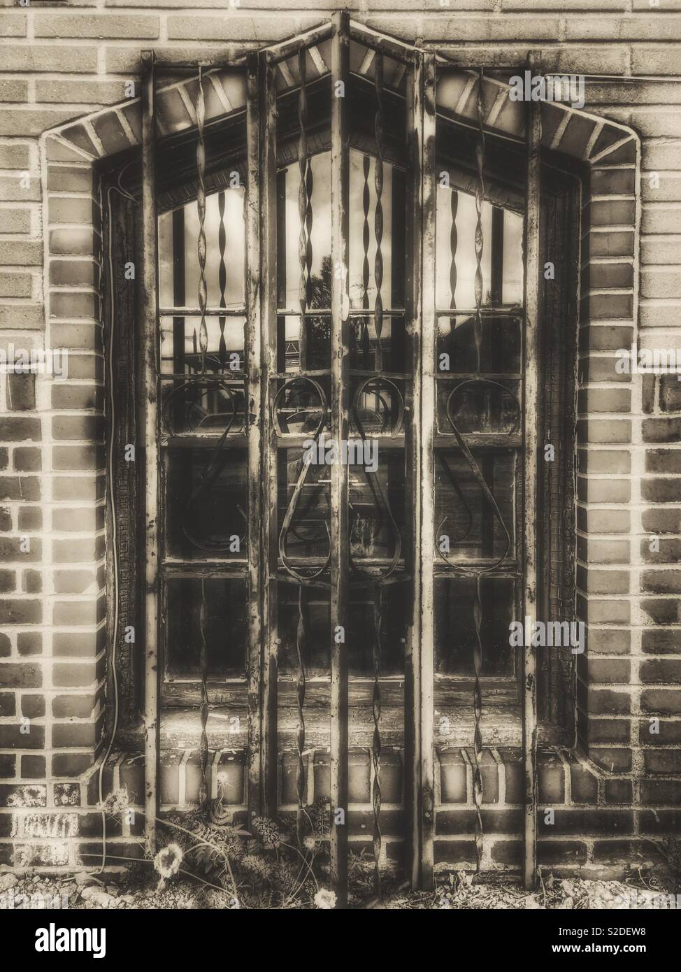 Iron grated window on old brick building - Smartphone Captured Stock Image