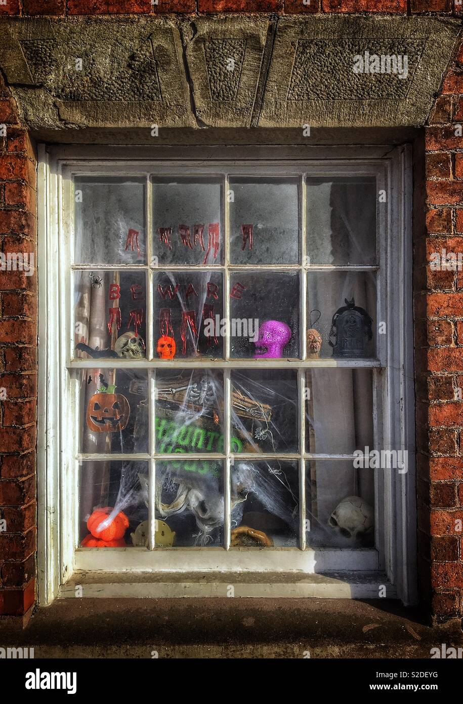 Sash window proclaiming haunted house - Smartphone Captured Stock Image