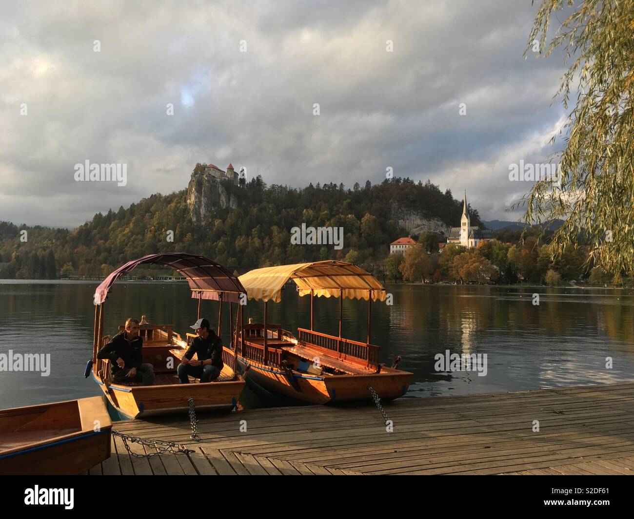 Gondolas on Lake Bled in the afternoon sun, Slovenia Stock Photo
