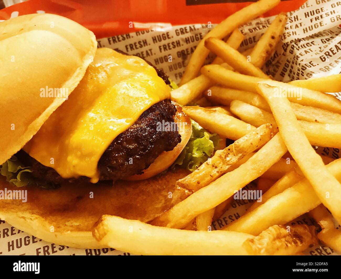 Burger and fries. Fastfood love. Stock Photo