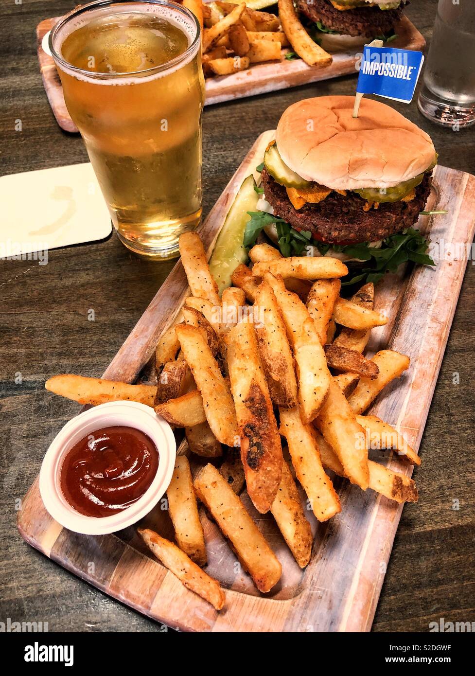 Famous vegan impossible burger with fries and cider Stock Photo