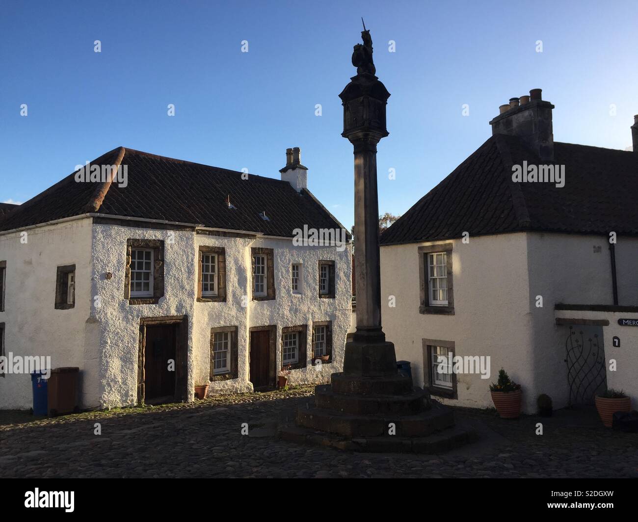 Mercat Cross and historic houses in evening light in the market square - Culross, Fife, Scotland Stock Photo