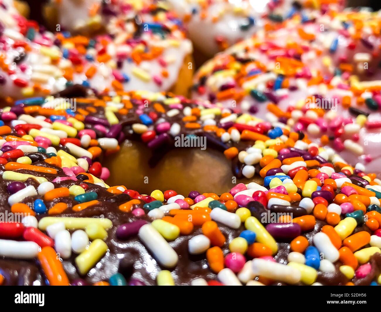 Donuts frosted with sprinkles Stock Photo Alamy