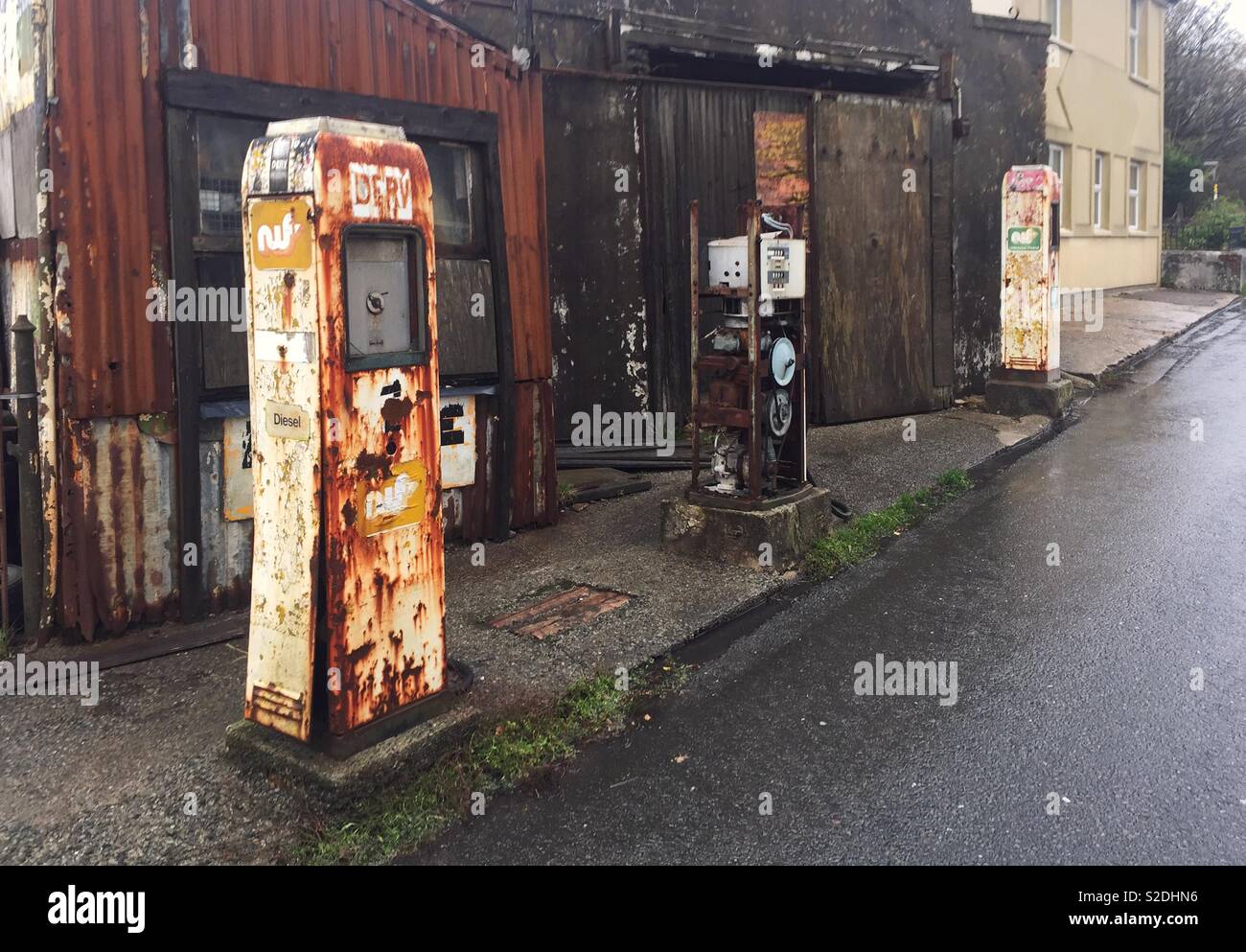 Abandoned fuel pumps on roadside in Wales Stock Photo