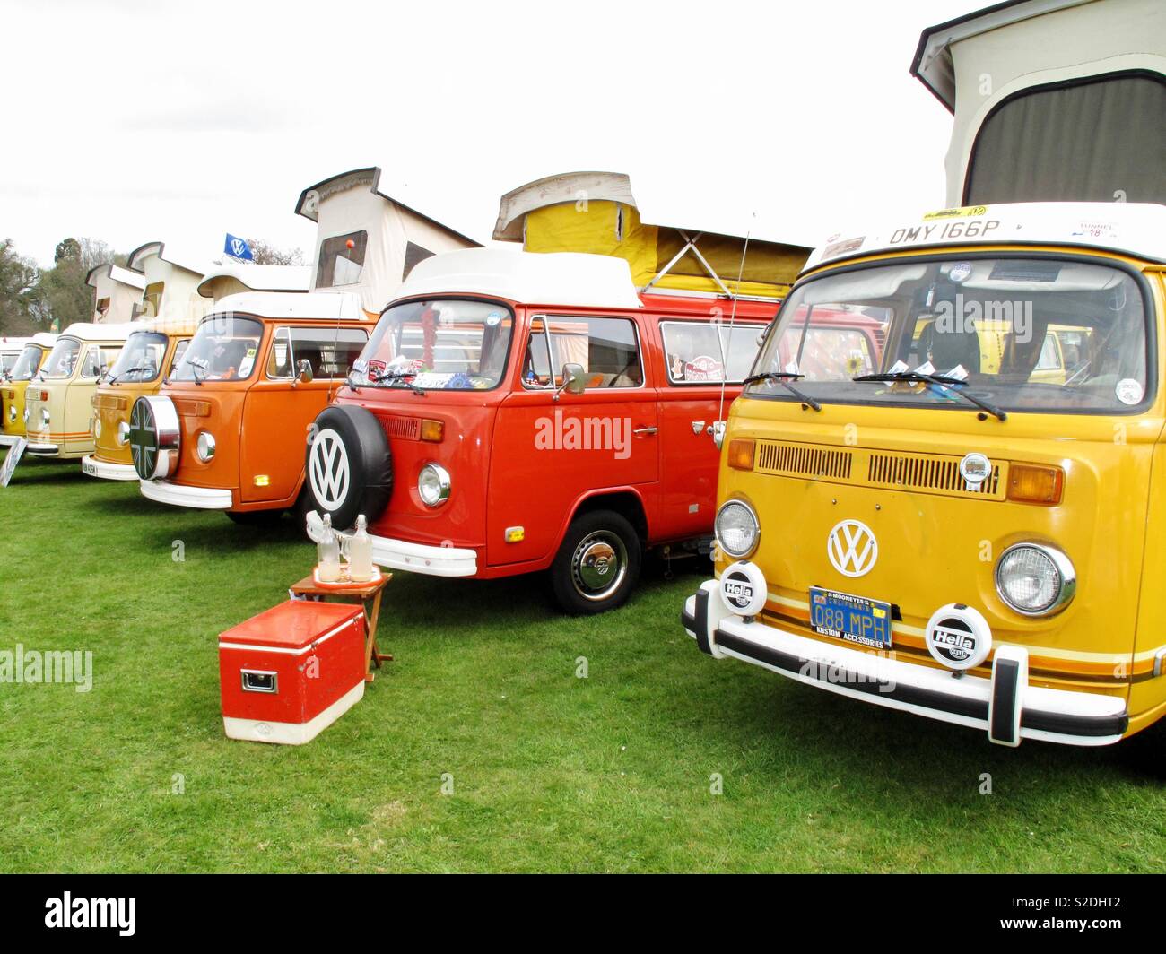 Red orange and yellow VW campervans at a Volkswagen show Stock Photo