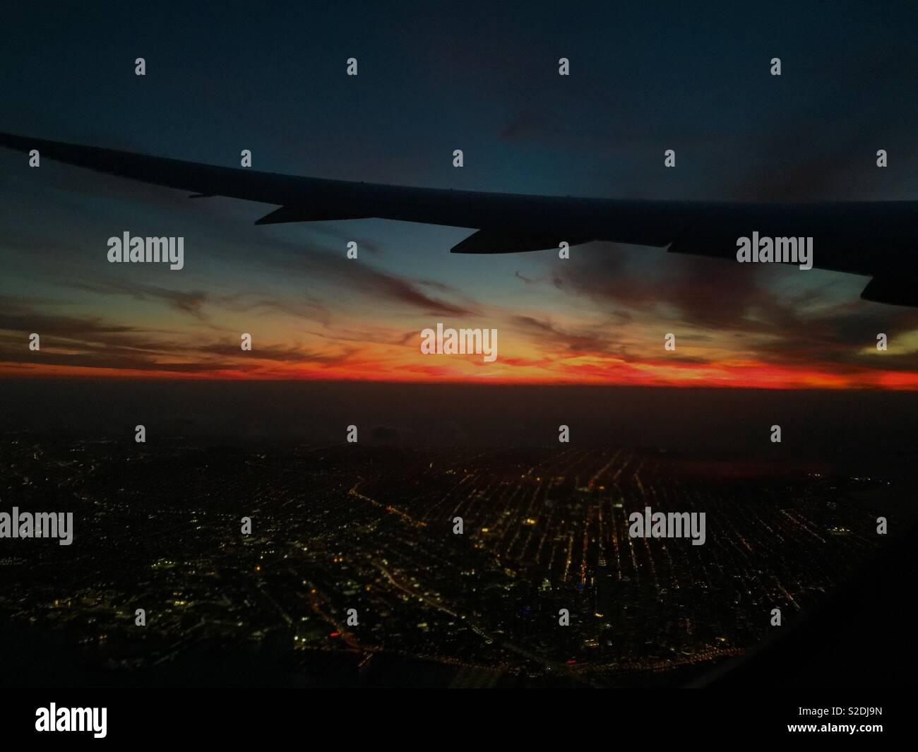 Airplane wing over San Francisco at dusk. - Smartphone Captured Stock Image