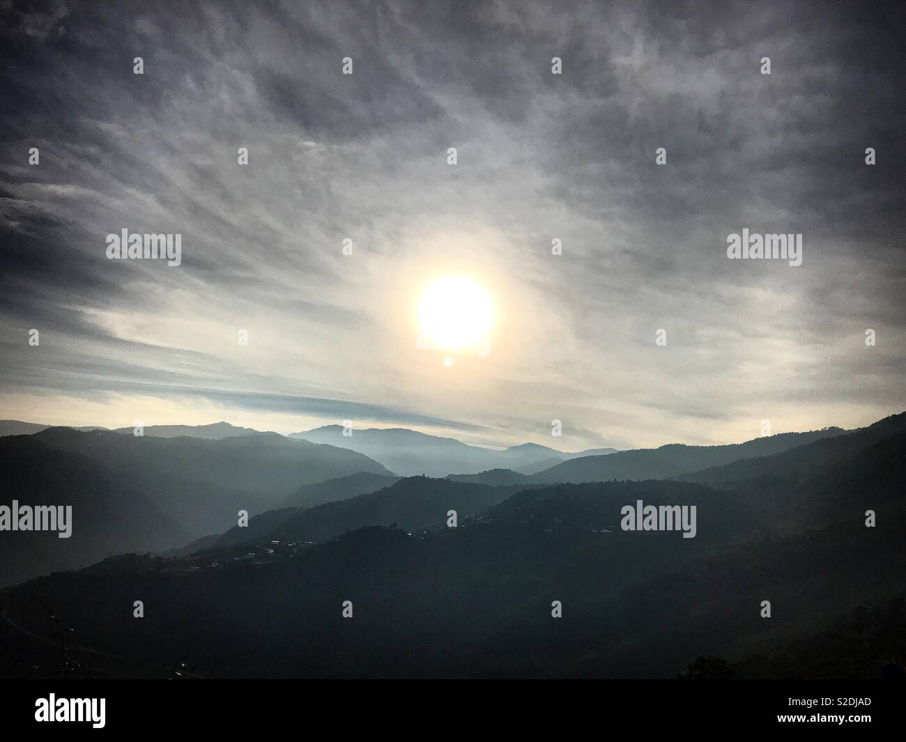 Clouds cover the sun over the Sierra Norte mountains in Lachatao, Oaxaca, Mexico - Smartphone Captured Stock Image