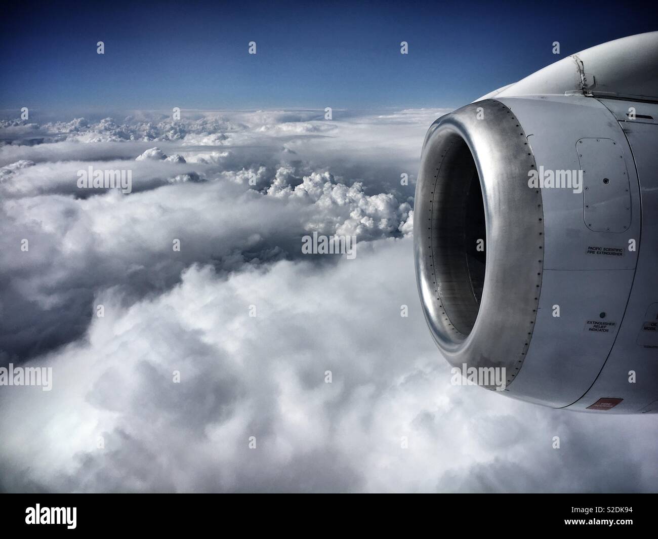 View outside an airplane, high above a sea of clouds - Smartphone Captured Stock Image
