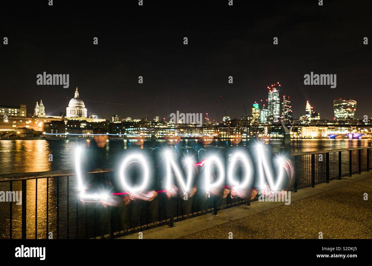 St Paul’s and the square mile from the South bank at night time with the word London painted in light in the foreground - Smartphone Captured Stock Image