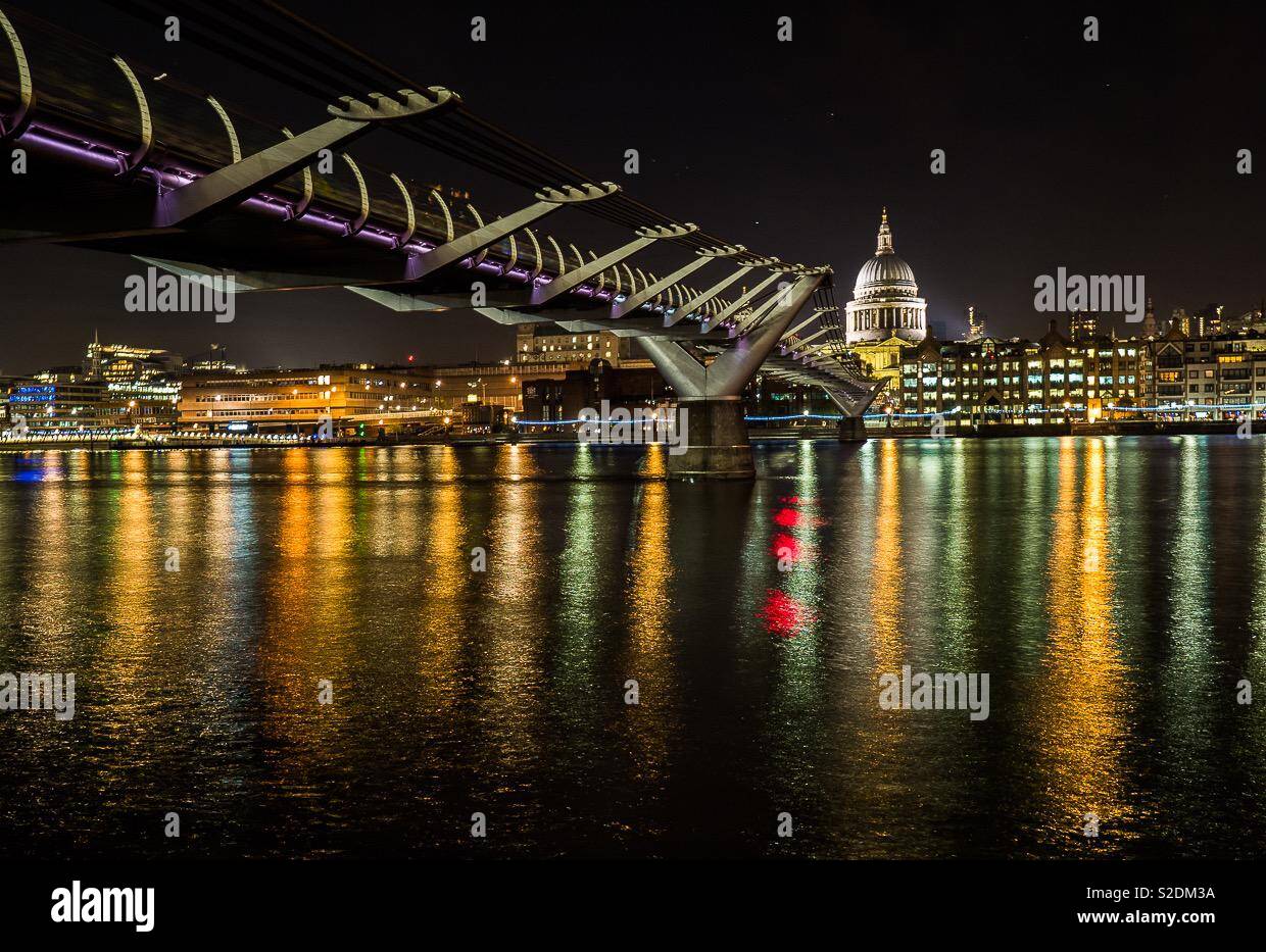Night time long exposure of St Paul’s and the millennium bridge from the southbank showing colourful reflections in the Thames - Smartphone Captured Stock Image