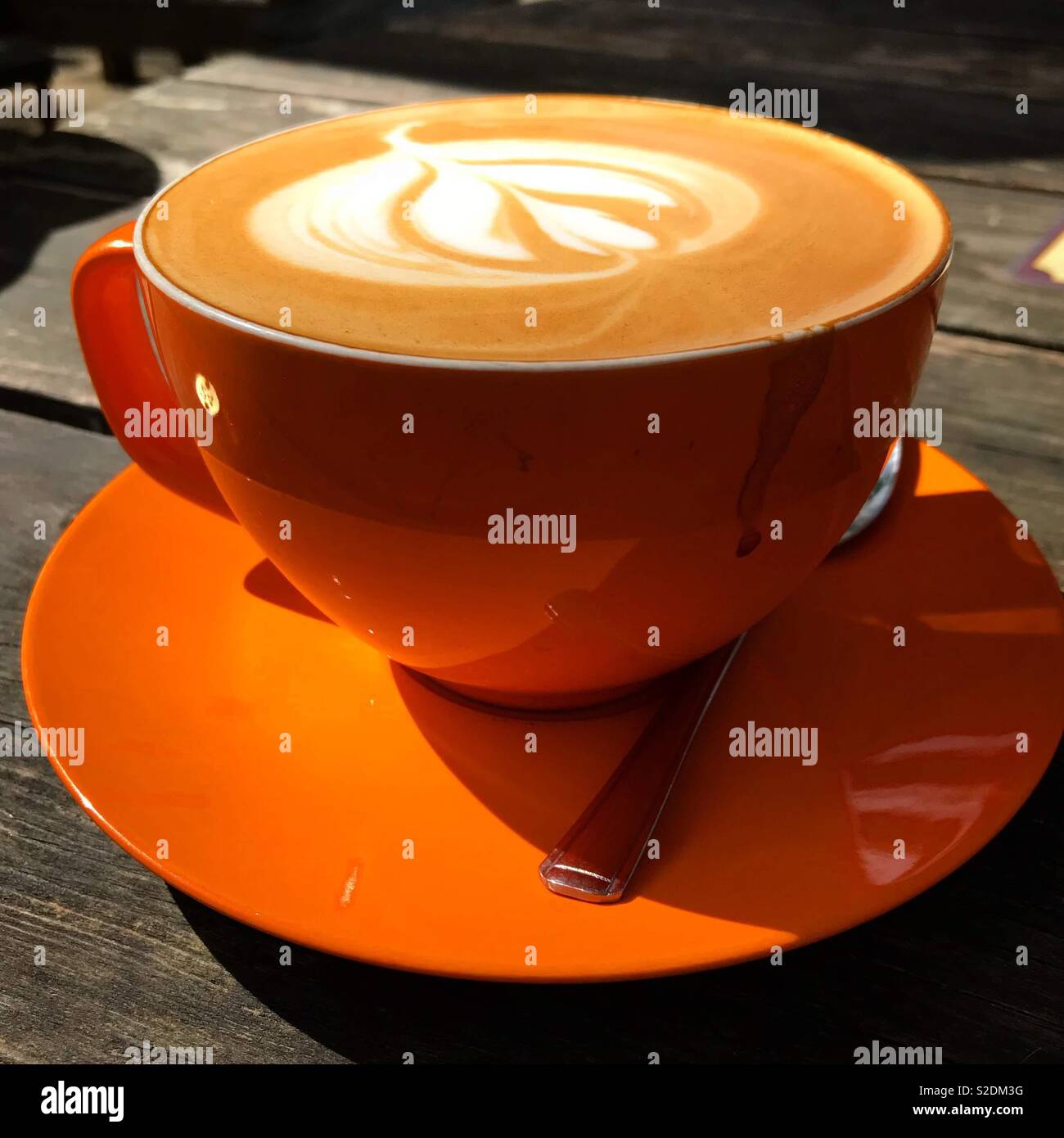 Flat white coffee in orange cup Stock Photo - Alamy