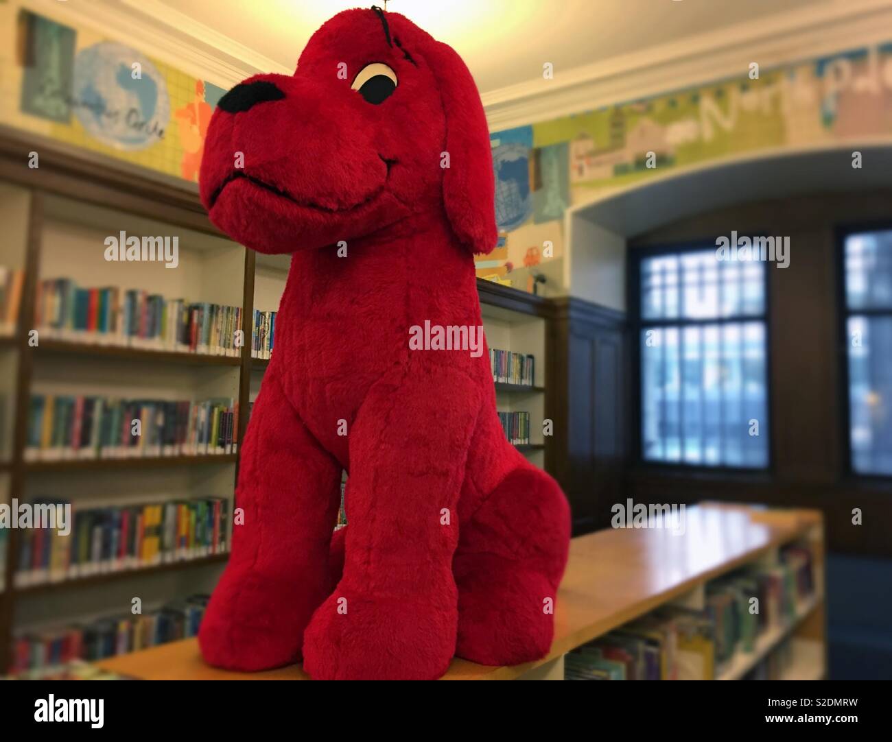 A large stuffed animal structure of Clifford the big red dog in the children’s library at the main library on fifth Avenue of the New York City Public library, NYC, USA Stock Photo