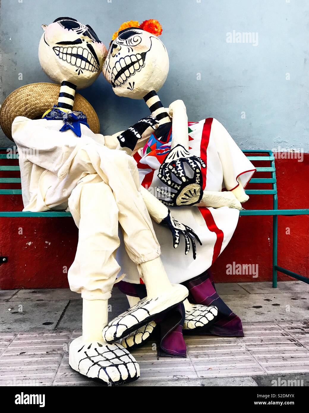 A couple of paper mache skeletons dressed with traditional Oaxacan costumes displayed during Day of the Dead celebrations in Oaxaca, Mexico - Smartphone Captured Stock Image